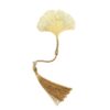 A gold metal hollow gingko leaf bookmark with a golden tassel and a white pearl accent on a white background.