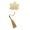 A gold metal hollow maple leaf bookmark with a golden tassel and a black bead accent on a white background.