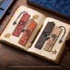 A complete 4-pack set of carved wooden bookmarks laid out inside an open antique book with a fountain pen.