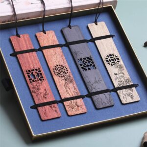 Set of 4 carved wooden bookmarks neatly packaged inside a blue velvet presentation gift box.