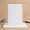 A5 blank notebook refill insert standing on paper stack with fountain pen and dried lavender